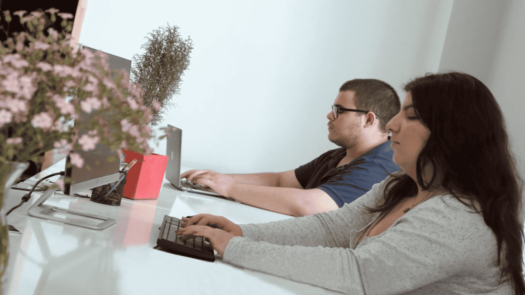 DRM's workers sitting at a desk with a laptop
