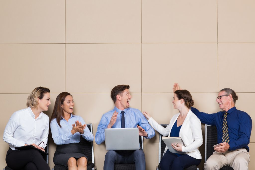 A group of people sitting in chairs, after making decision