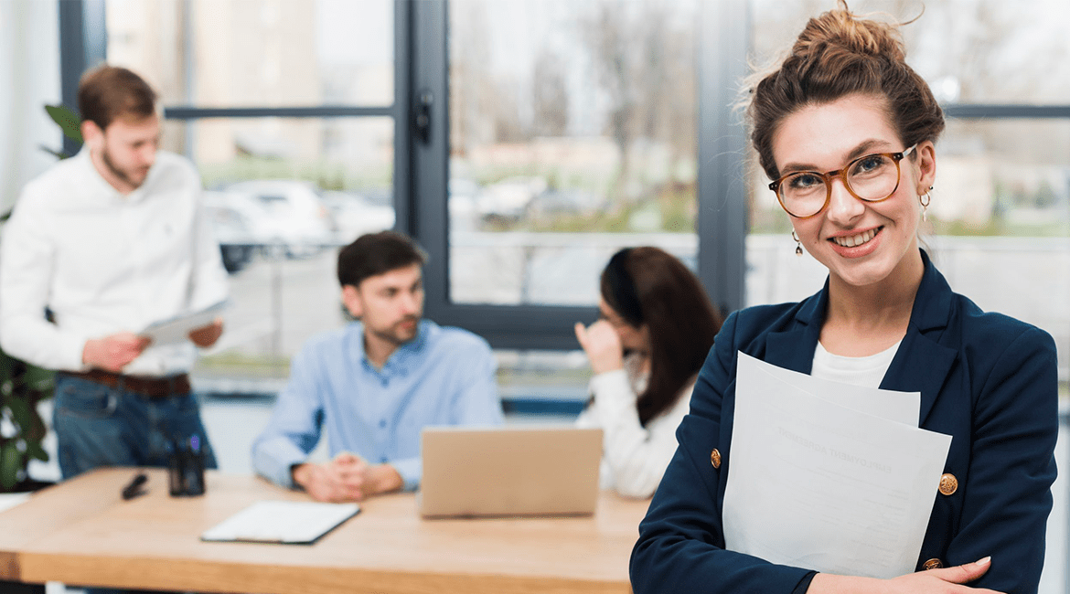 a woman in a suit with glasses and a woman in a suit with glasses