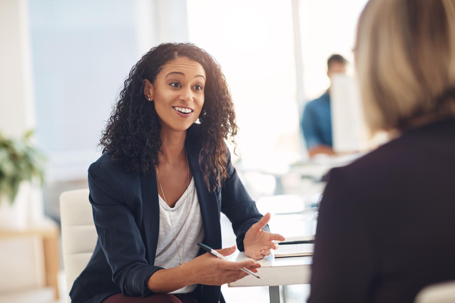 Interview with excited and confident HR manager who is talking to a candidate in her office