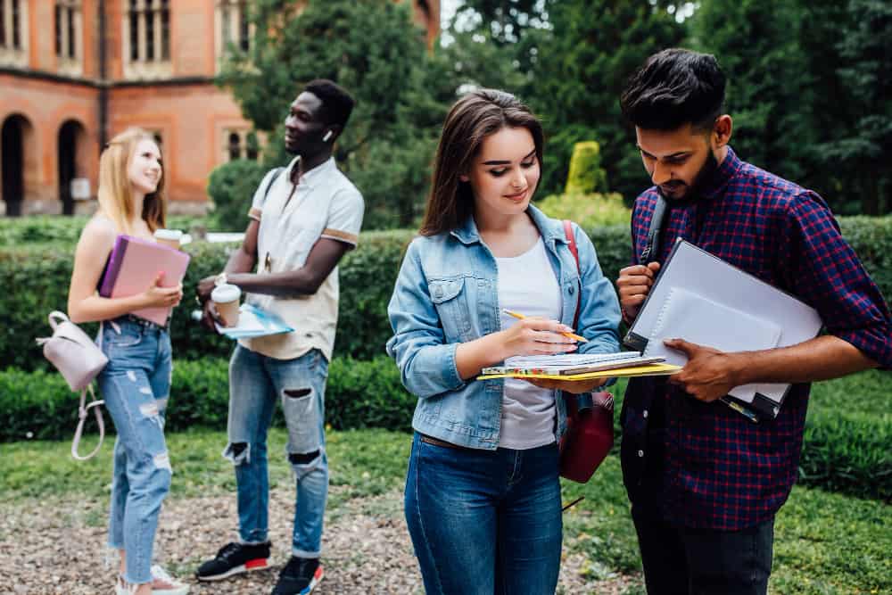 A recruiter networking with college students on campus