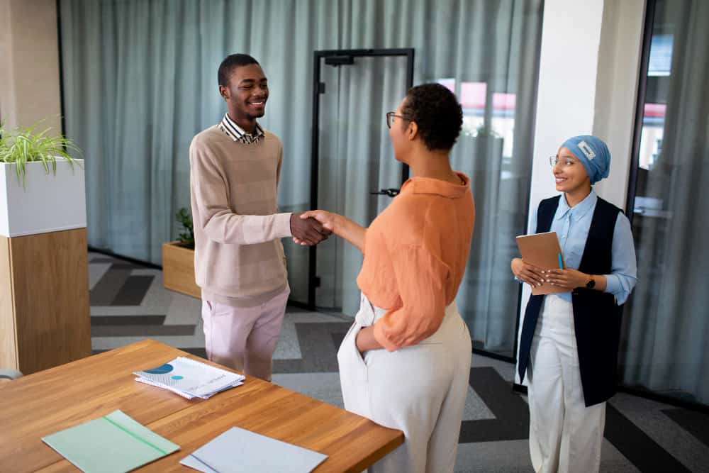 Recruiter Welcoming Candidate after Focusing on Candidate Experience