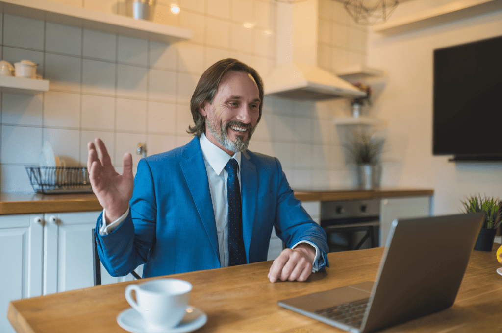 A man in a blue suit having a video call