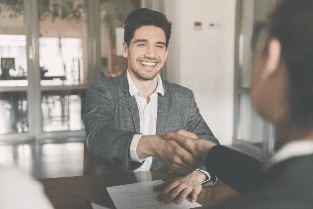 A man shaking hands and smiling