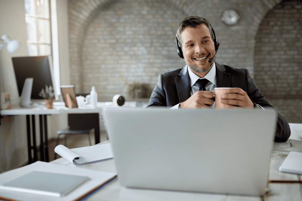 An Individual Having an Video Conference While Working Office Drinking Coffee
