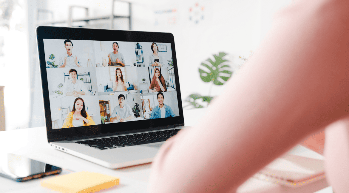 An individual using a laptop while talking to collegaues through video chat