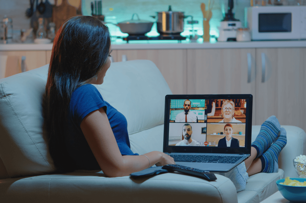 woman-having-web-chat-conference-while-sitting-on-sofa-in-the-living-room