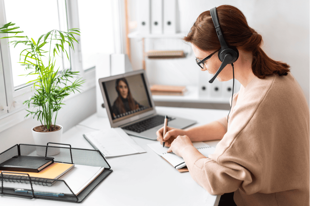 Woman Noting Something While Having an Online Meeting