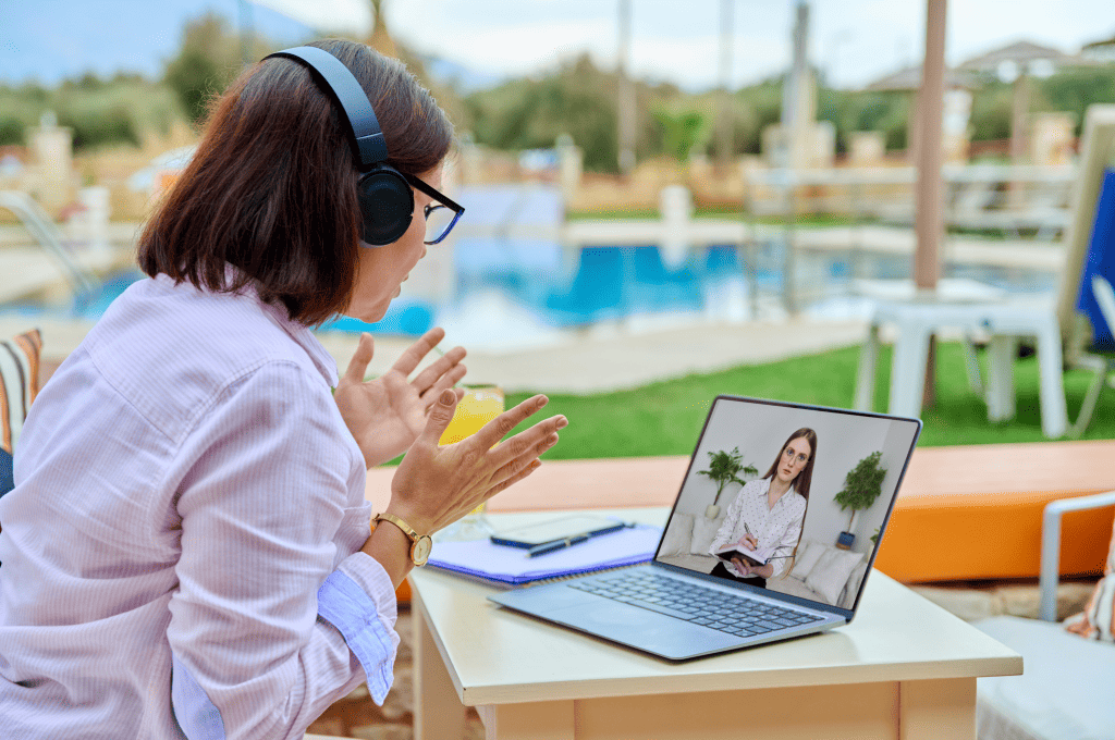 woman-wearig-headphones-while-talking-online-with-other-person