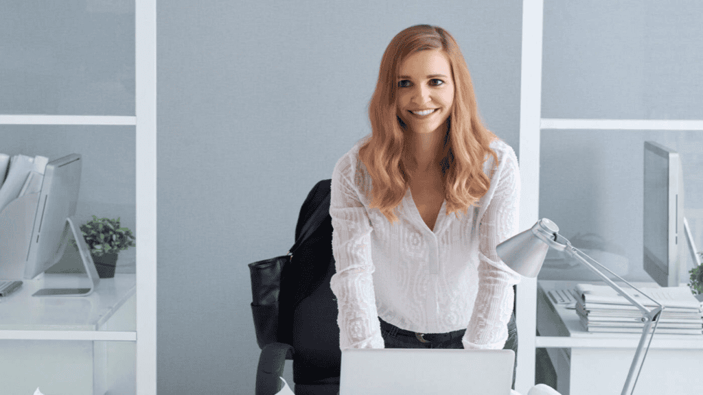 a woman sitting at a desk with a laptop