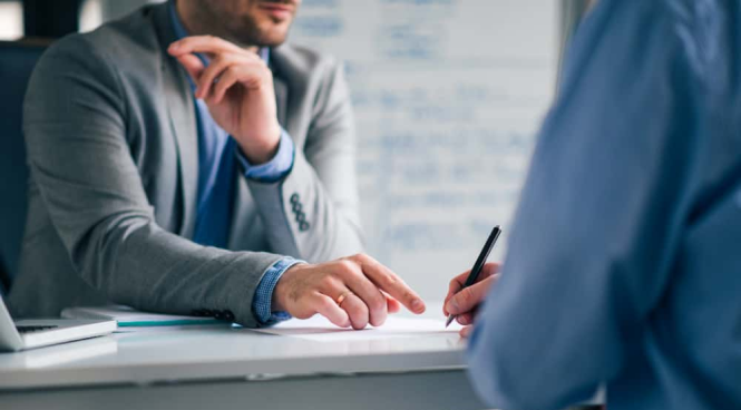 Two professionals finalizing a hiring agreement, symbolizing successful recruitment decisions.
